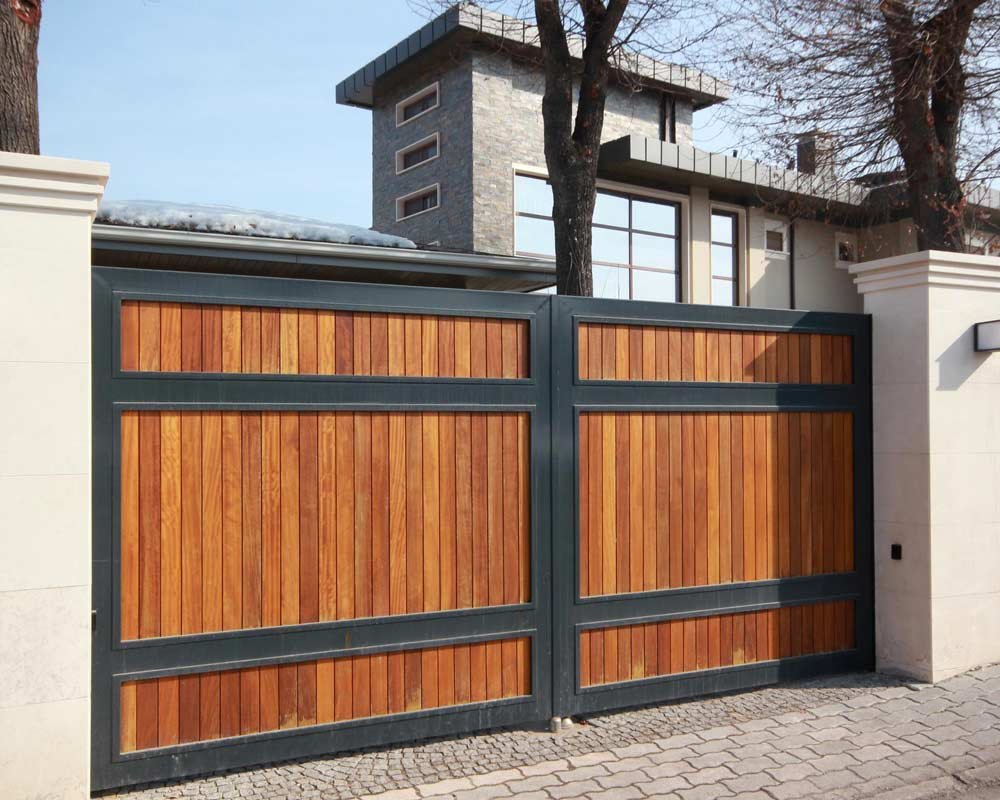 Portón de herrería de una casa de gran tamaño elaborado con madera y soleras de acero